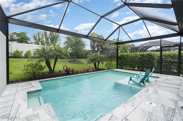 view of swimming pool with glass enclosure and a patio area