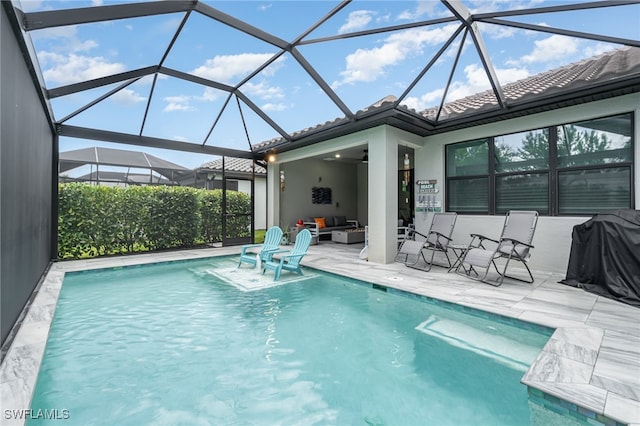 view of pool with a patio and a lanai