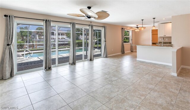 spare room with sink, light tile patterned floors, and ceiling fan