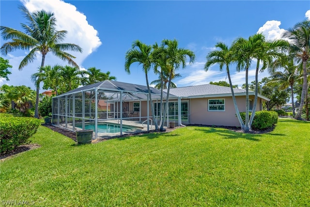 back of property with a lanai and a lawn