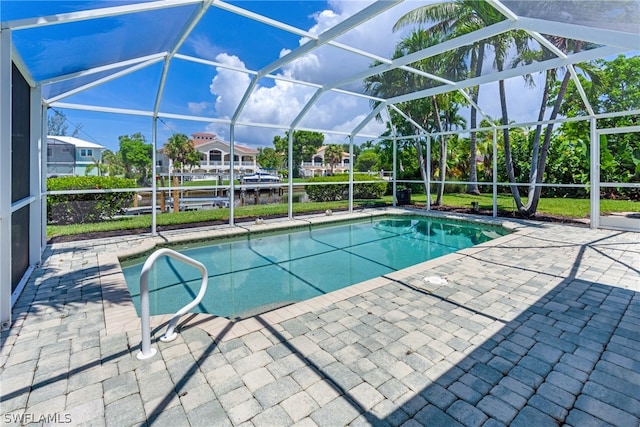 view of pool with a patio area and a lanai