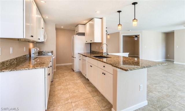 kitchen featuring light tile patterned flooring, sink, dark stone counters, and ceiling fan