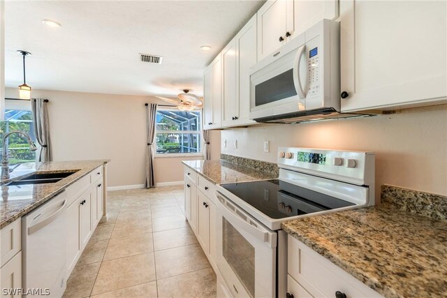 kitchen featuring sink, a healthy amount of sunlight, white cabinets, and white appliances