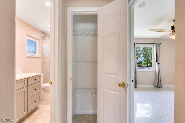 bathroom featuring vanity, tile patterned floors, ceiling fan, and toilet