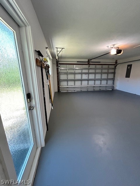 garage featuring electric panel and a garage door opener