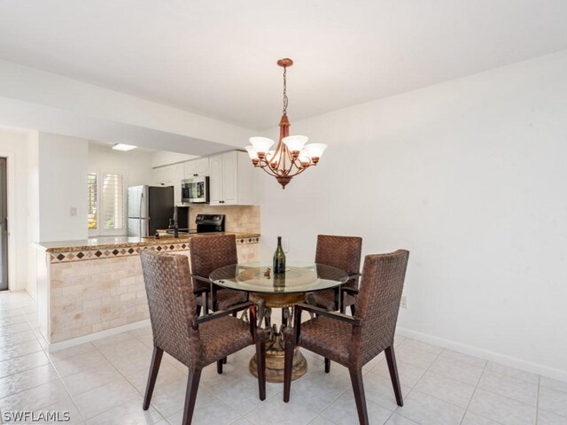 dining room with light tile patterned floors and an inviting chandelier