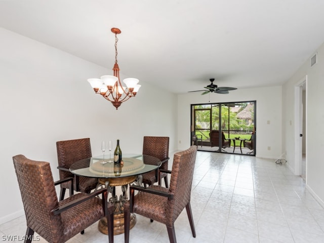 tiled dining space featuring ceiling fan with notable chandelier