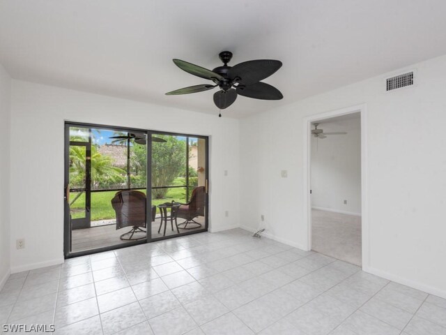 spare room with light tile patterned flooring and ceiling fan