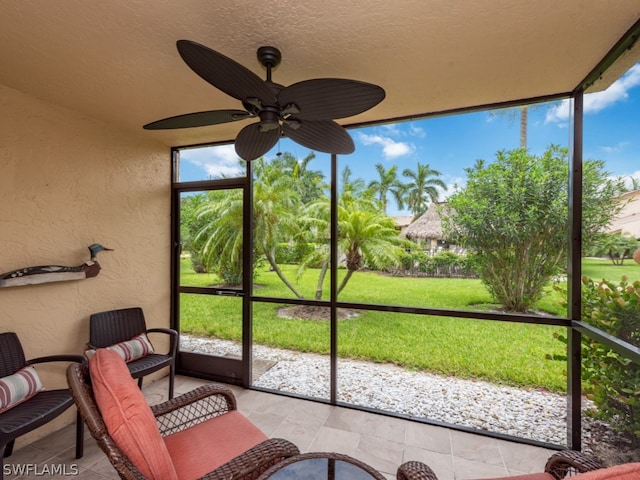 sunroom / solarium featuring ceiling fan