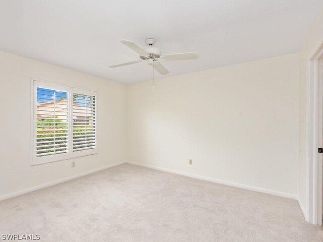 empty room featuring light colored carpet and ceiling fan