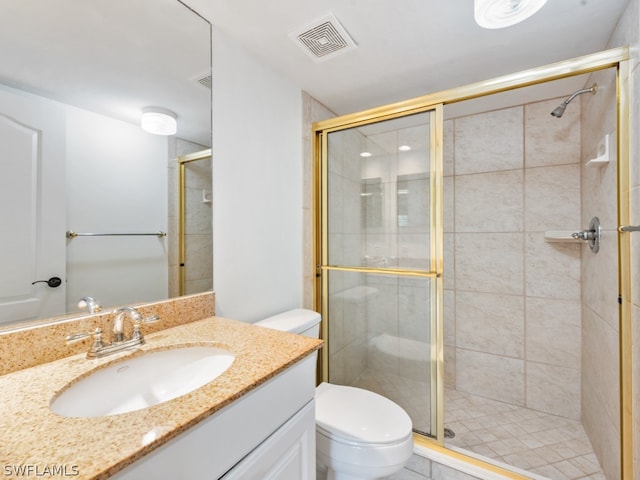 bathroom with a shower with door, toilet, and vanity