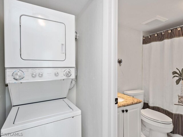 washroom featuring stacked washer and dryer