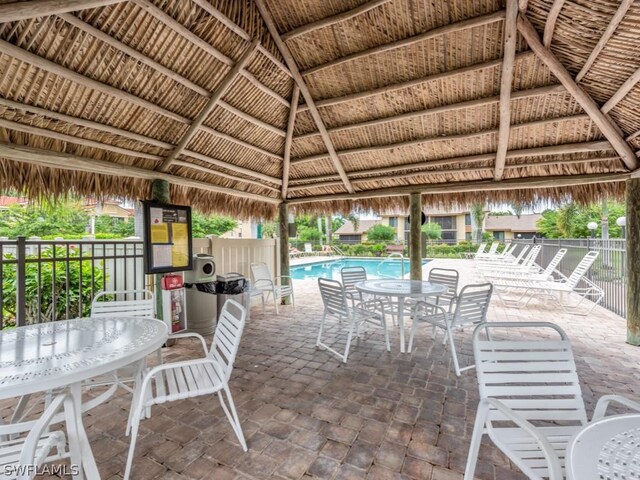 view of patio / terrace featuring a community pool and a gazebo