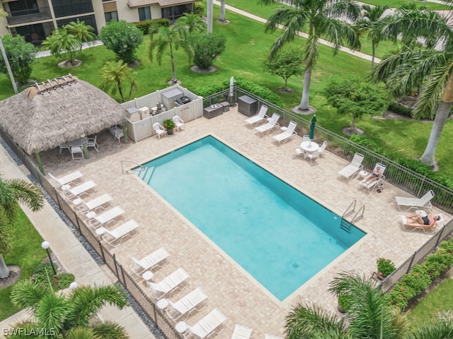 view of swimming pool with a yard and a patio area