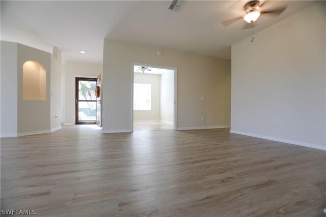 spare room with hardwood / wood-style floors and ceiling fan