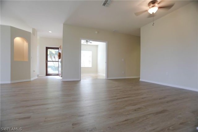 unfurnished room featuring ceiling fan and light wood-type flooring