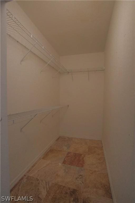 spacious closet with tile patterned floors