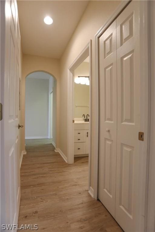 hall featuring sink and light hardwood / wood-style flooring