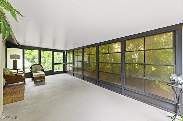 unfurnished sunroom with lofted ceiling