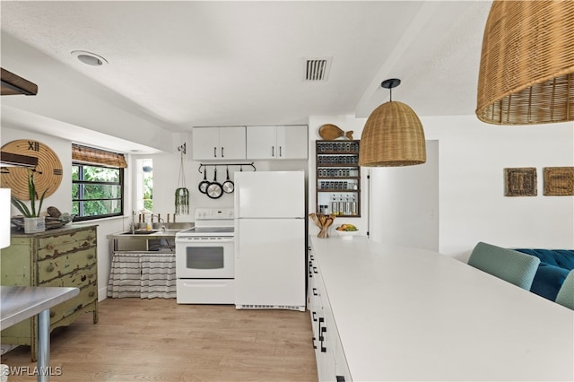 kitchen with decorative light fixtures, white cabinetry, light wood-type flooring, white appliances, and sink