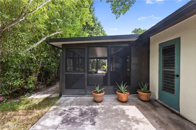 entrance to property featuring a patio area