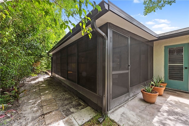 view of property exterior featuring a sunroom