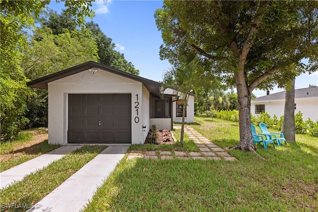 ranch-style house with a garage and a front lawn