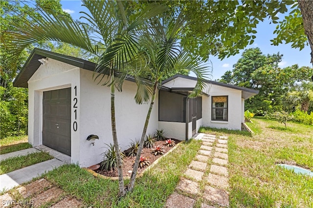 view of front facade with a garage and a front lawn