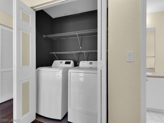 laundry room with tile patterned floors and separate washer and dryer