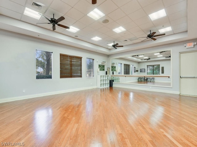 workout area with light wood-type flooring and a drop ceiling