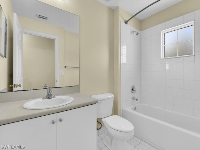 full bathroom featuring tile patterned flooring, vanity, toilet, and tiled shower / bath