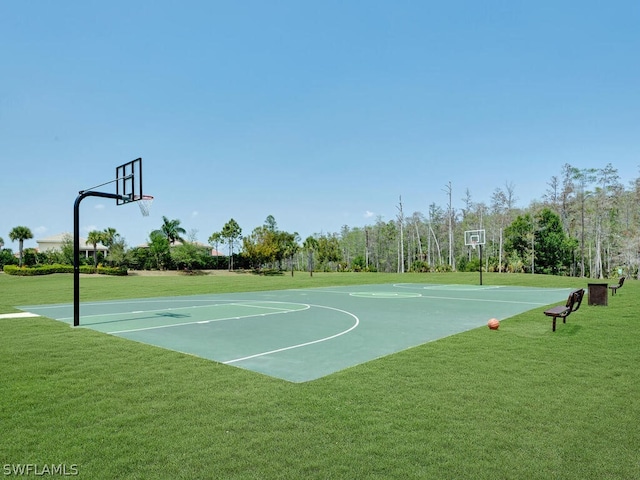 view of basketball court with a lawn