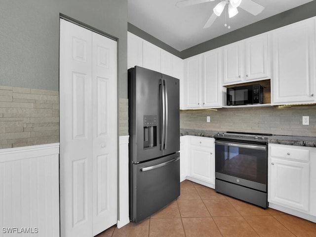 kitchen with white cabinets, ceiling fan, decorative backsplash, light tile patterned floors, and appliances with stainless steel finishes