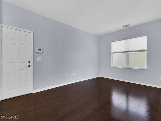 spare room with dark hardwood / wood-style floors