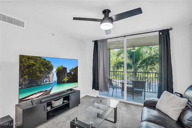 carpeted living room with ceiling fan