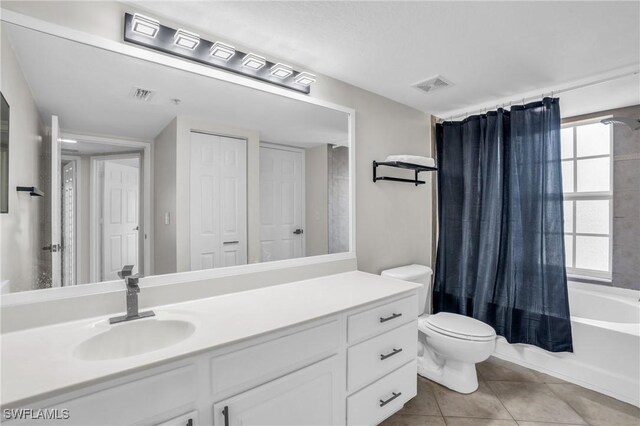 full bathroom with tile patterned flooring, shower / tub combo, toilet, and vanity