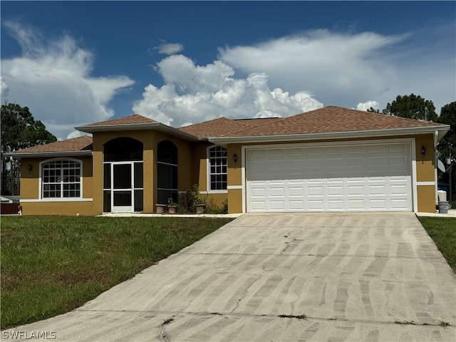 view of front facade featuring a garage and a front lawn