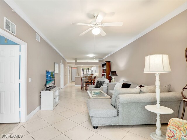 living room with ceiling fan, light tile patterned flooring, and crown molding