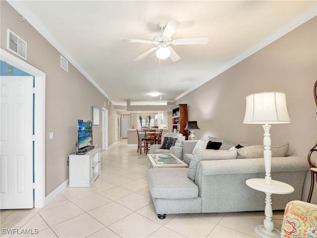 tiled living room with ceiling fan and ornamental molding