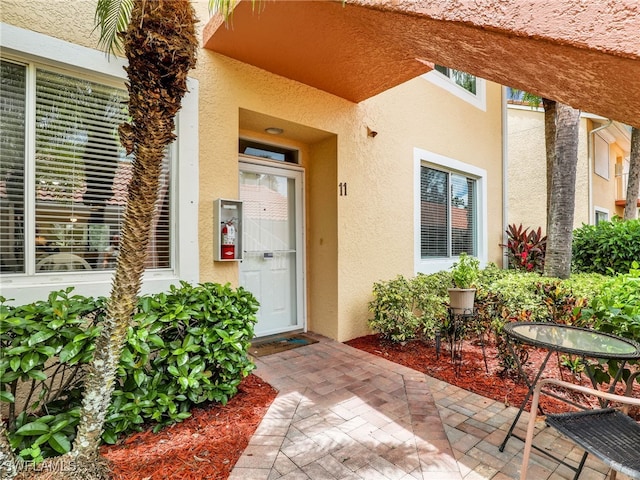 property entrance featuring a patio area