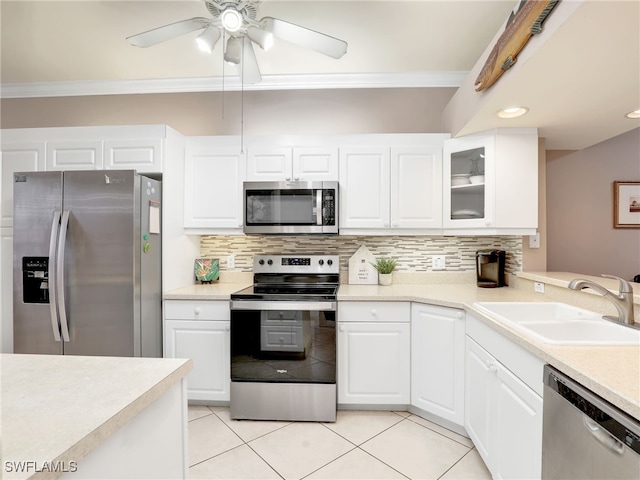 kitchen with stainless steel appliances, sink, and white cabinetry