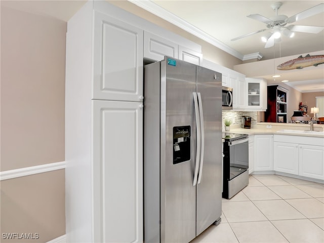 kitchen featuring sink, white cabinetry, crown molding, light tile patterned floors, and stainless steel appliances