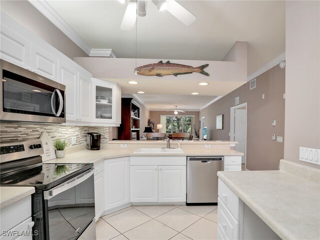 kitchen featuring ornamental molding, appliances with stainless steel finishes, sink, and white cabinetry