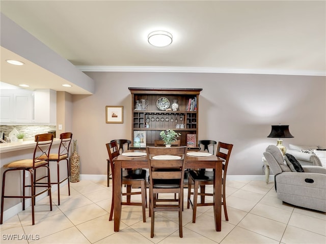 tiled dining room with ornamental molding