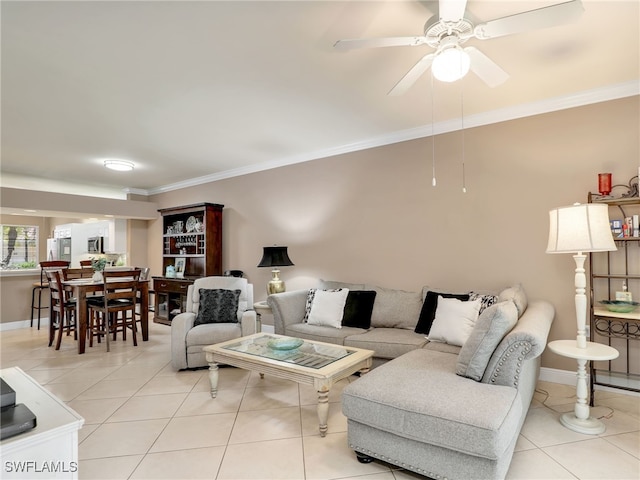 tiled living room with crown molding and ceiling fan