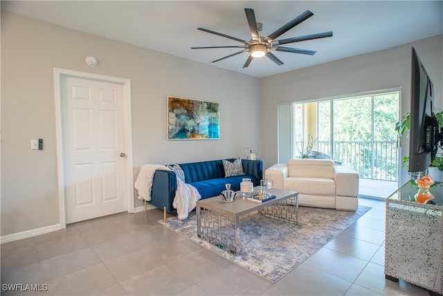 living room with ceiling fan and light tile patterned flooring