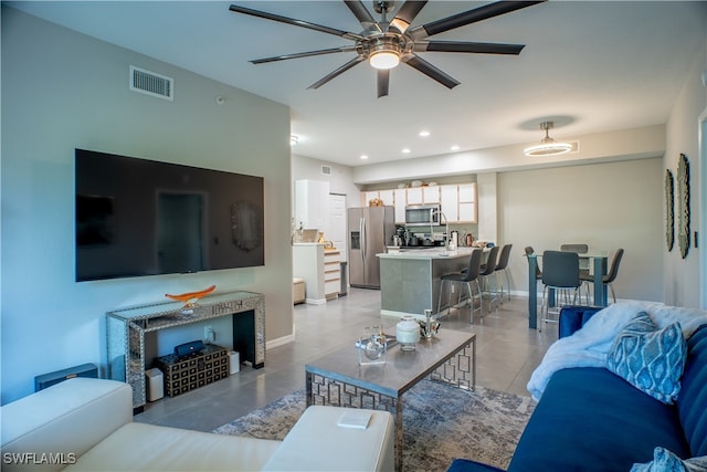 living room featuring ceiling fan and light tile patterned floors