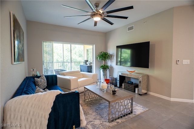 living room featuring ceiling fan and tile patterned flooring