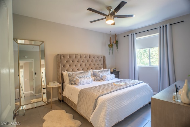 bedroom with ceiling fan and tile patterned floors