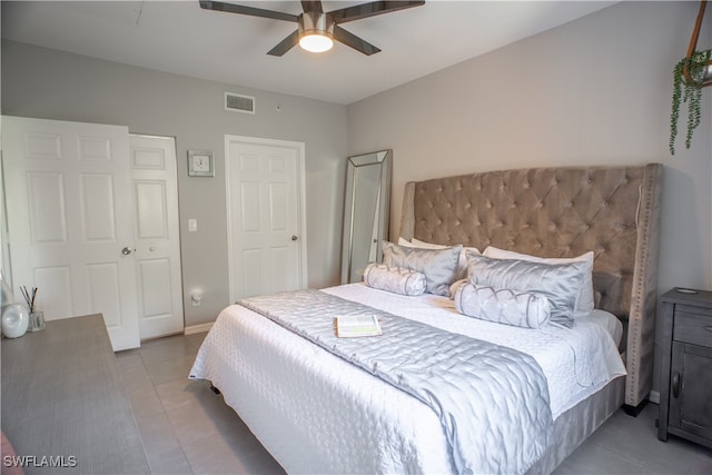 tiled bedroom with ceiling fan